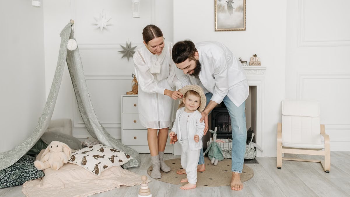 Parents with child enjoying indoor family time in a cozy setting.